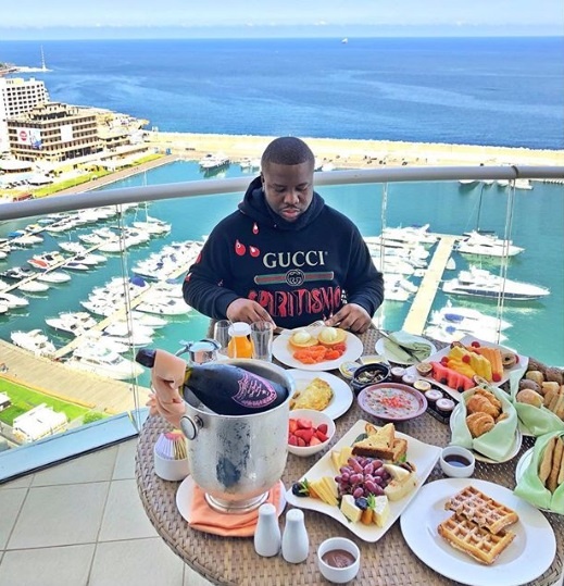 Image of Hushpuppi (cybercriminal involved in social engineering scams) taken from Instagram eating gourmet brunch at beautiful oceanside hotel.